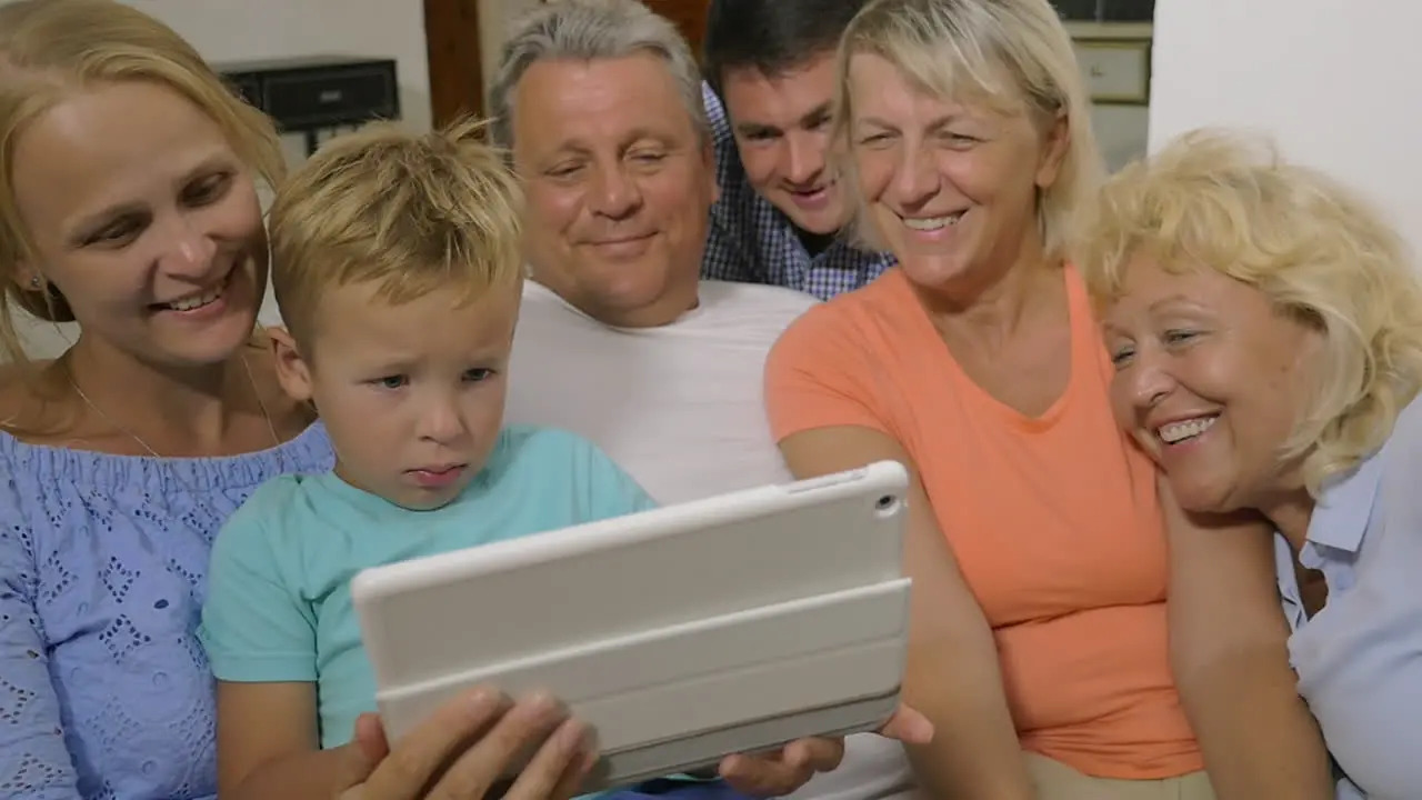 Big family watching video on touch pad