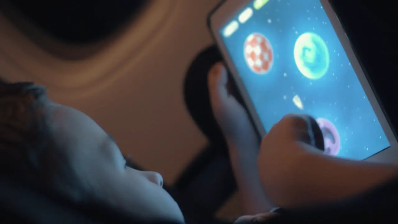 Boy spending flight time with tablet PC