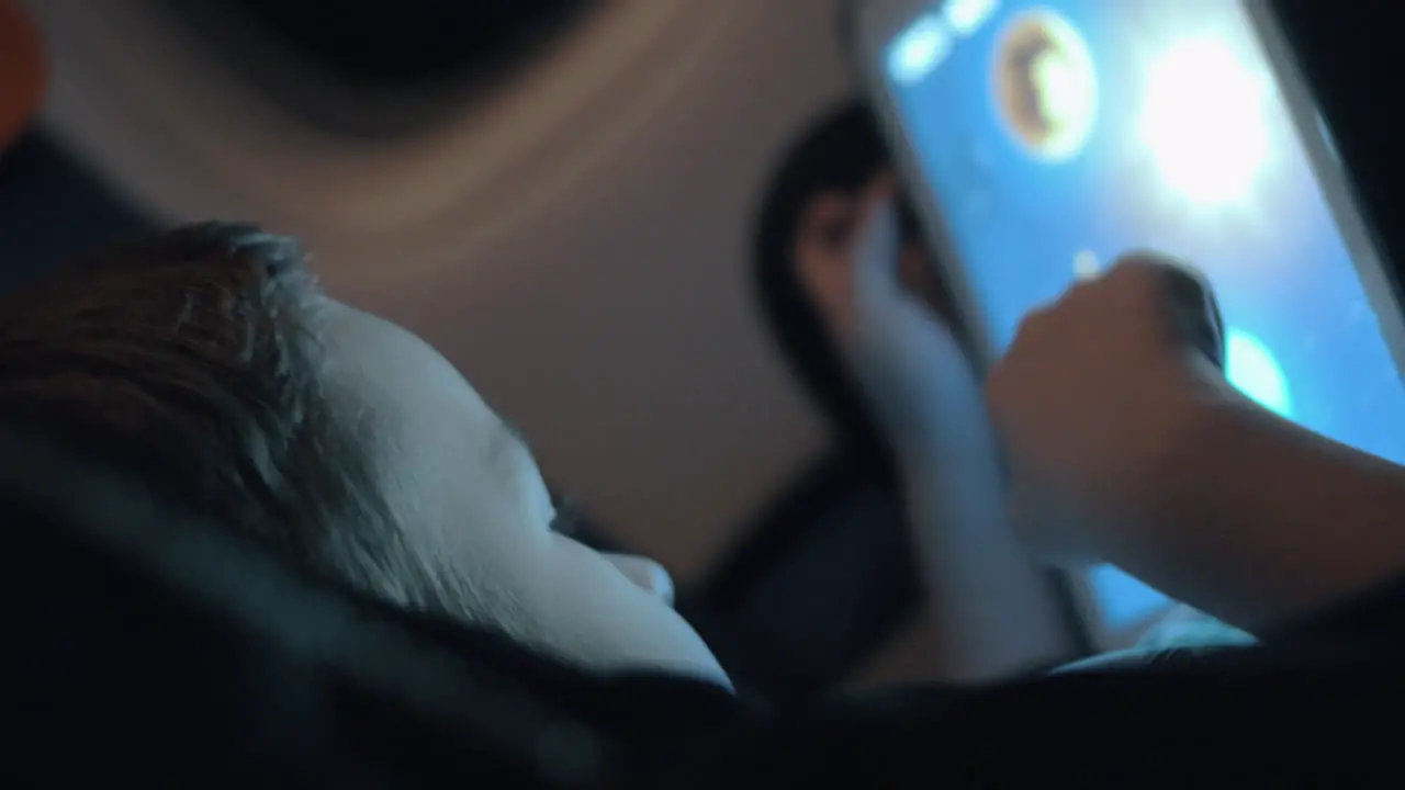 Night air travel and boy playing on touch pad