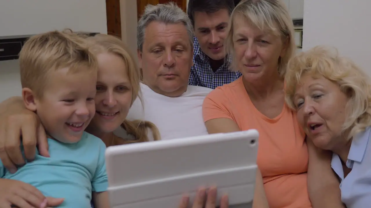 Family watching video on tablet computer