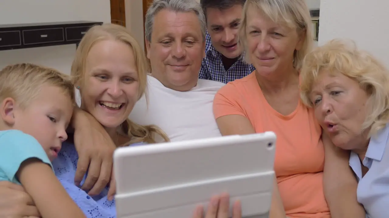 Big family watching video on digital tablet