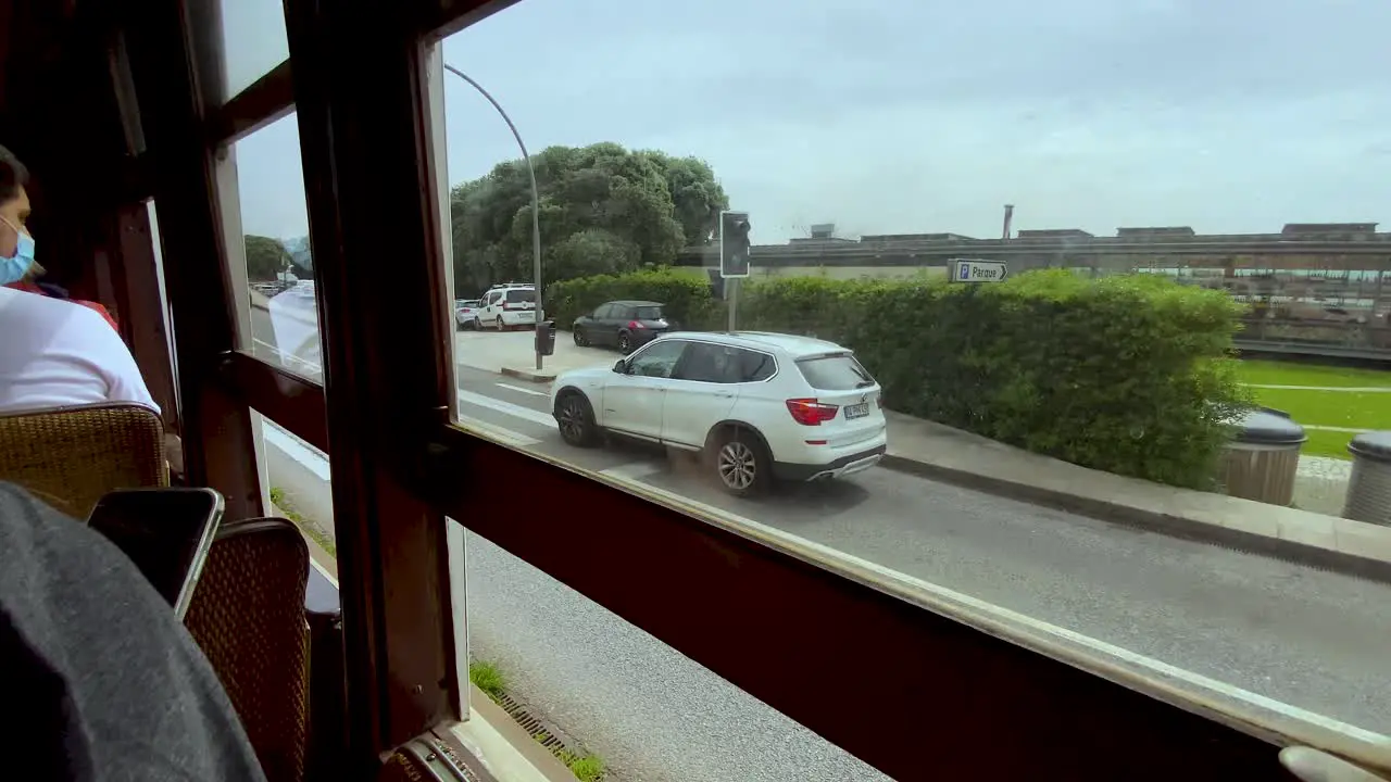 Commuter's Viewpoint Of The Public Roadway And Other Passengers Inside A Locomotive Transport In Porto Portugal During Pandemic