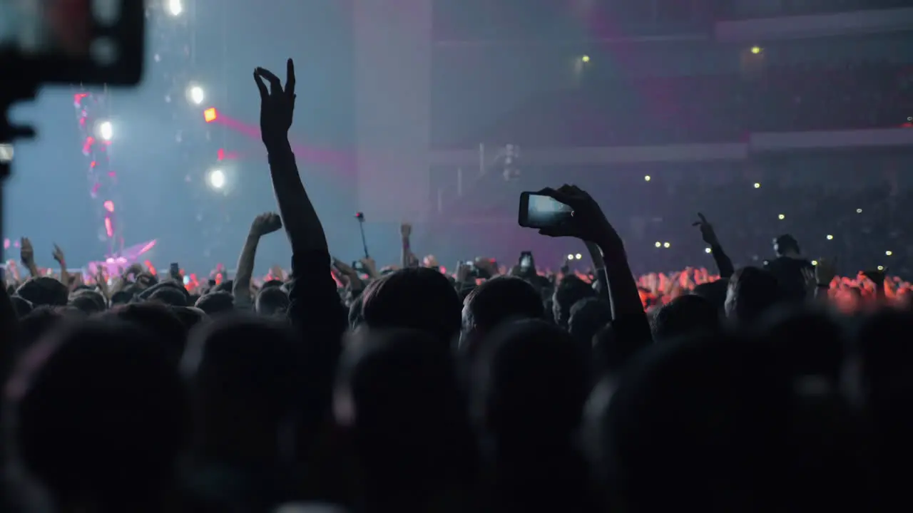 Crowd of young music fans dancing at the concert