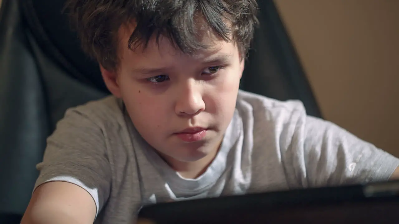 Kid with tablet PC at the table