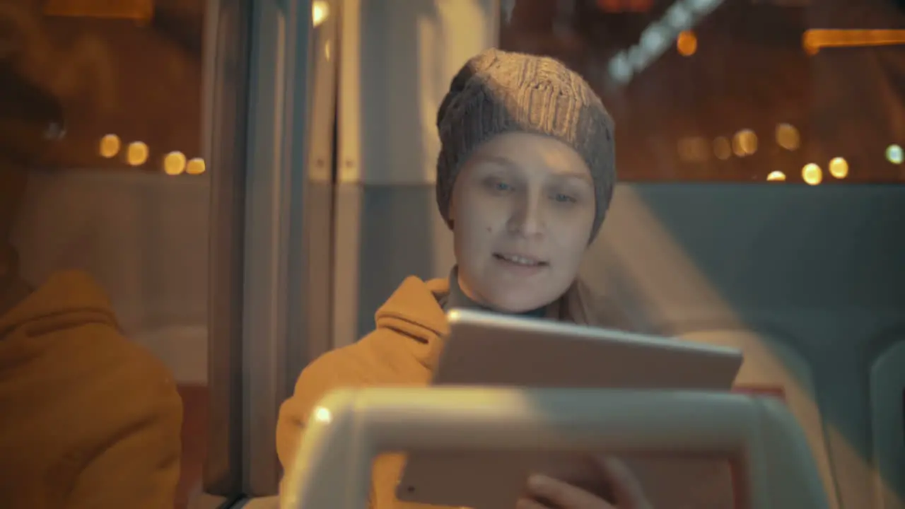 Woman traveling by bus with touch pad