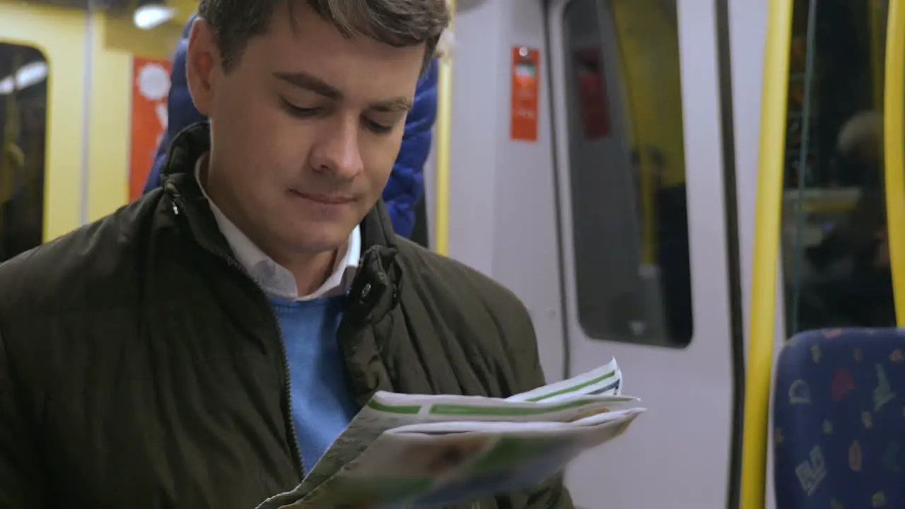 Commuter spending time with newspaper in underground train