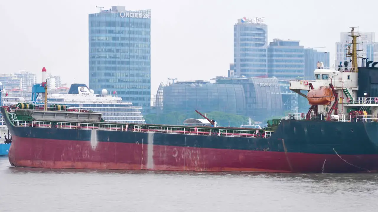 Cargo ship is slowly moving across the Huangpu River in Shanghai China