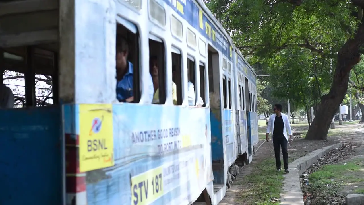 Tram car with people moves from very close to a young male chance of accident