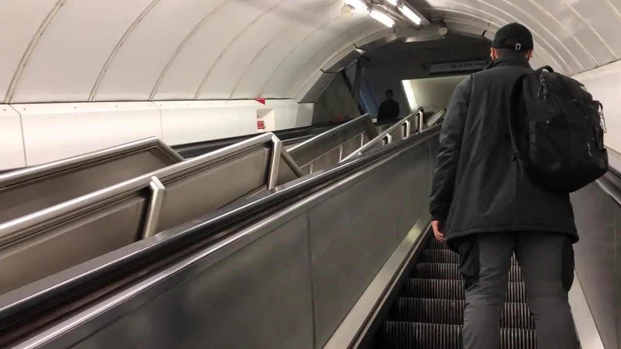 Commuter in Paddington Station using the escalator in the London Underground London UK