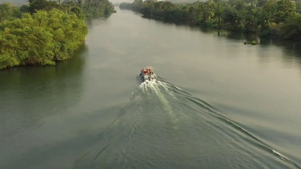 cruise boat with people on river with greens_3