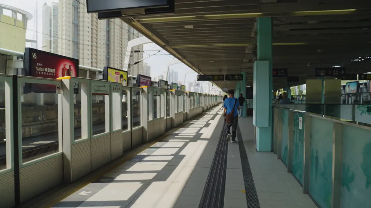 Dynamic shot of people waiting for their train on the platform in Hong Kong Asia