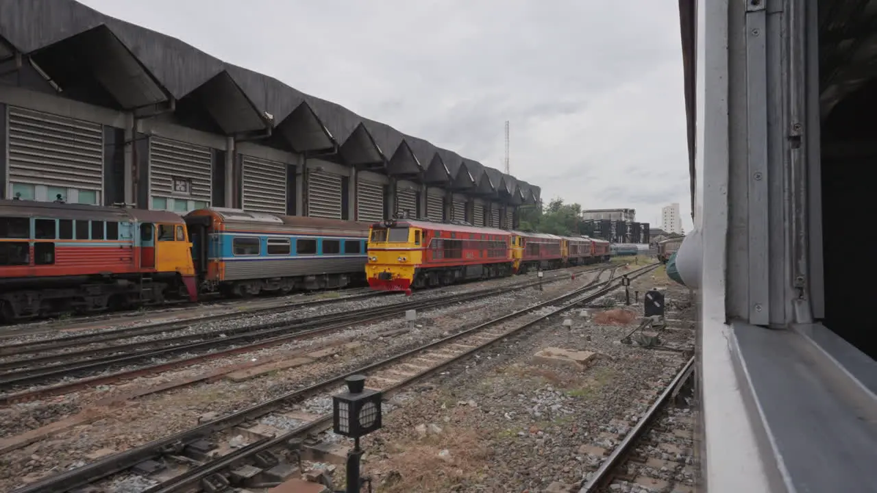 Looking out Train Window Leaving Station in Bangkok Thailand