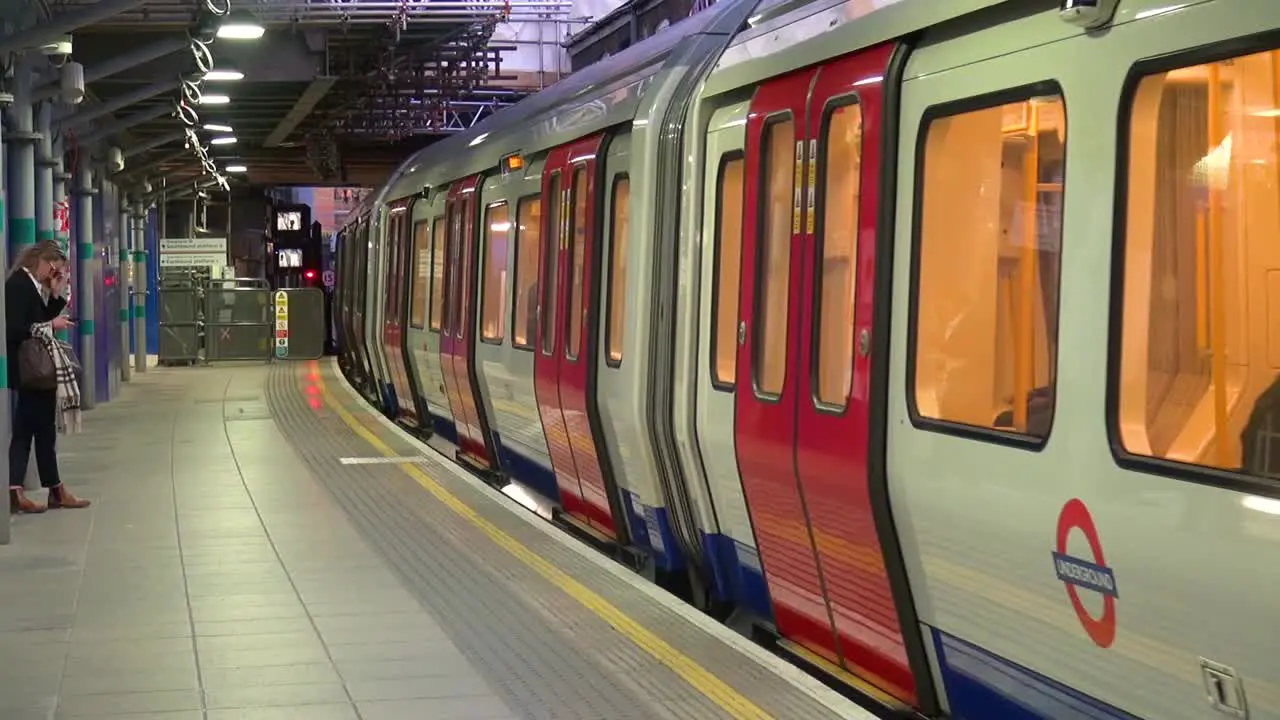 London Underground District Line closing doors and departing from Whitechapel Tube Station in Tower Hamlets on Westbound platform