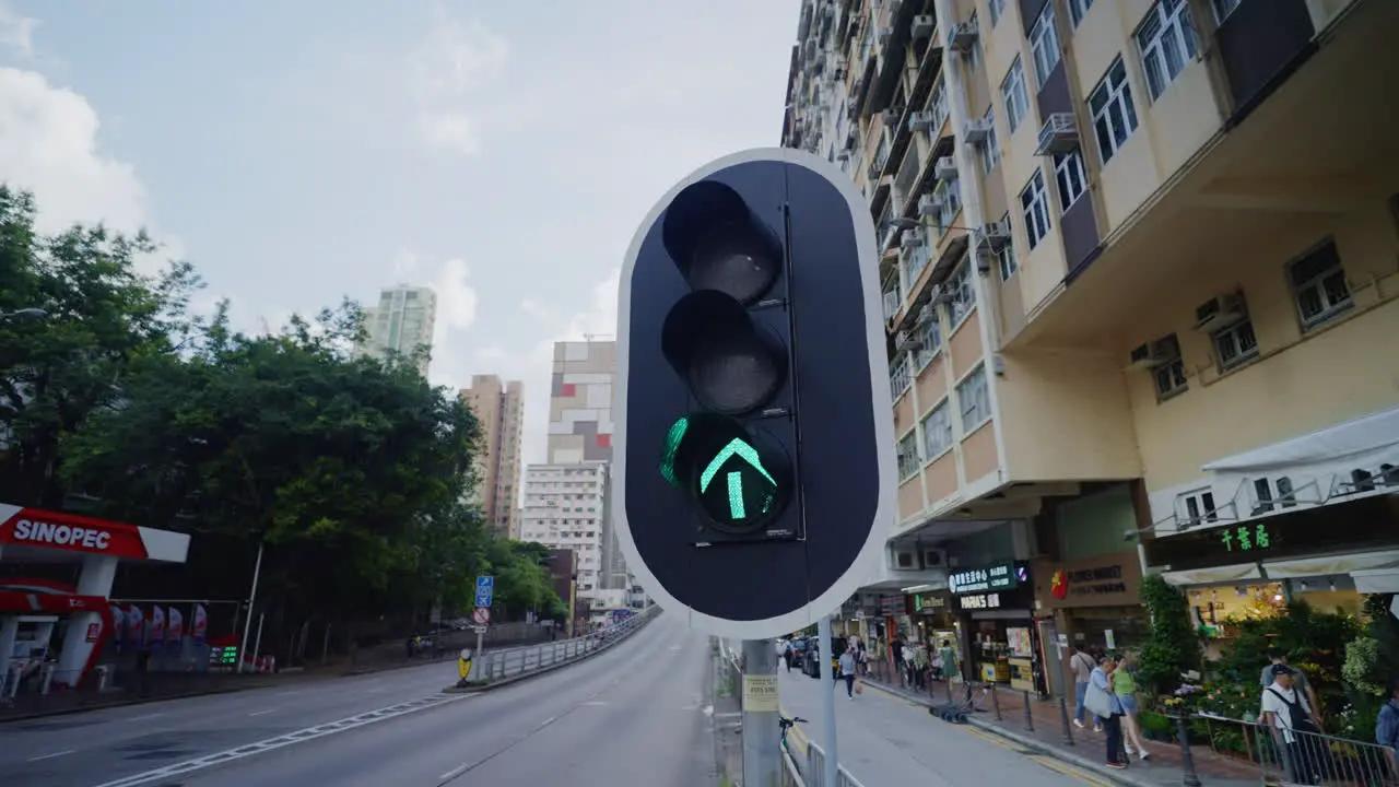 High-angle wide shot of traffic light changing on busy street with vehicles