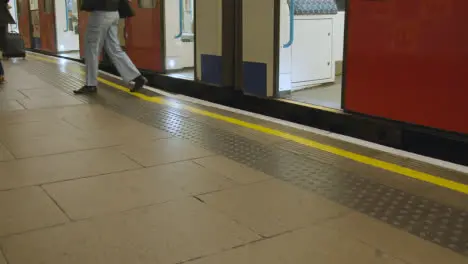 Close Up Of Tube Train Arriving At Platform Of Underground Station In London UK With Passengers Getting Off