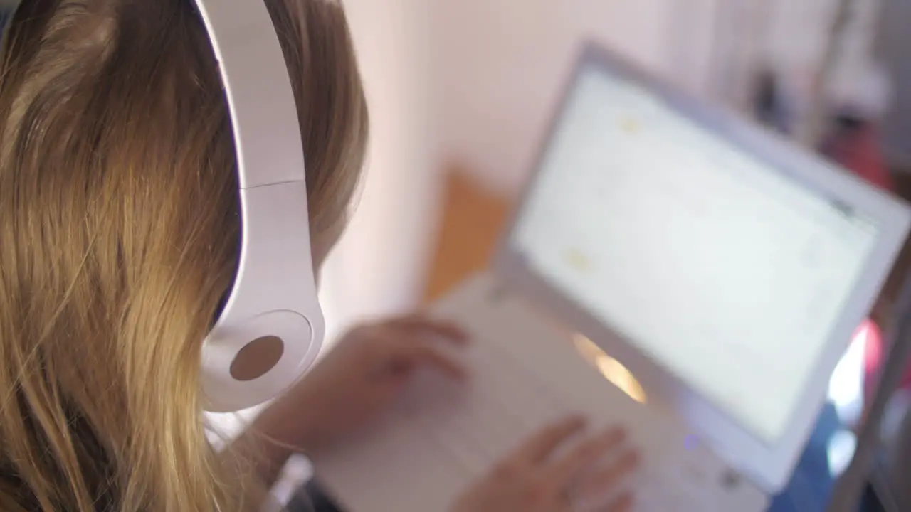 Woman in headphones using laptop