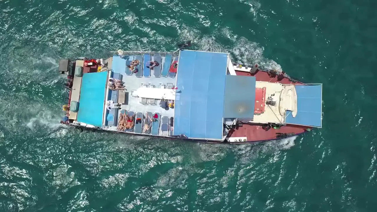 Overhead Shot Of People Enjoying Sun Relaxing On Big Blue Boat Cyprus