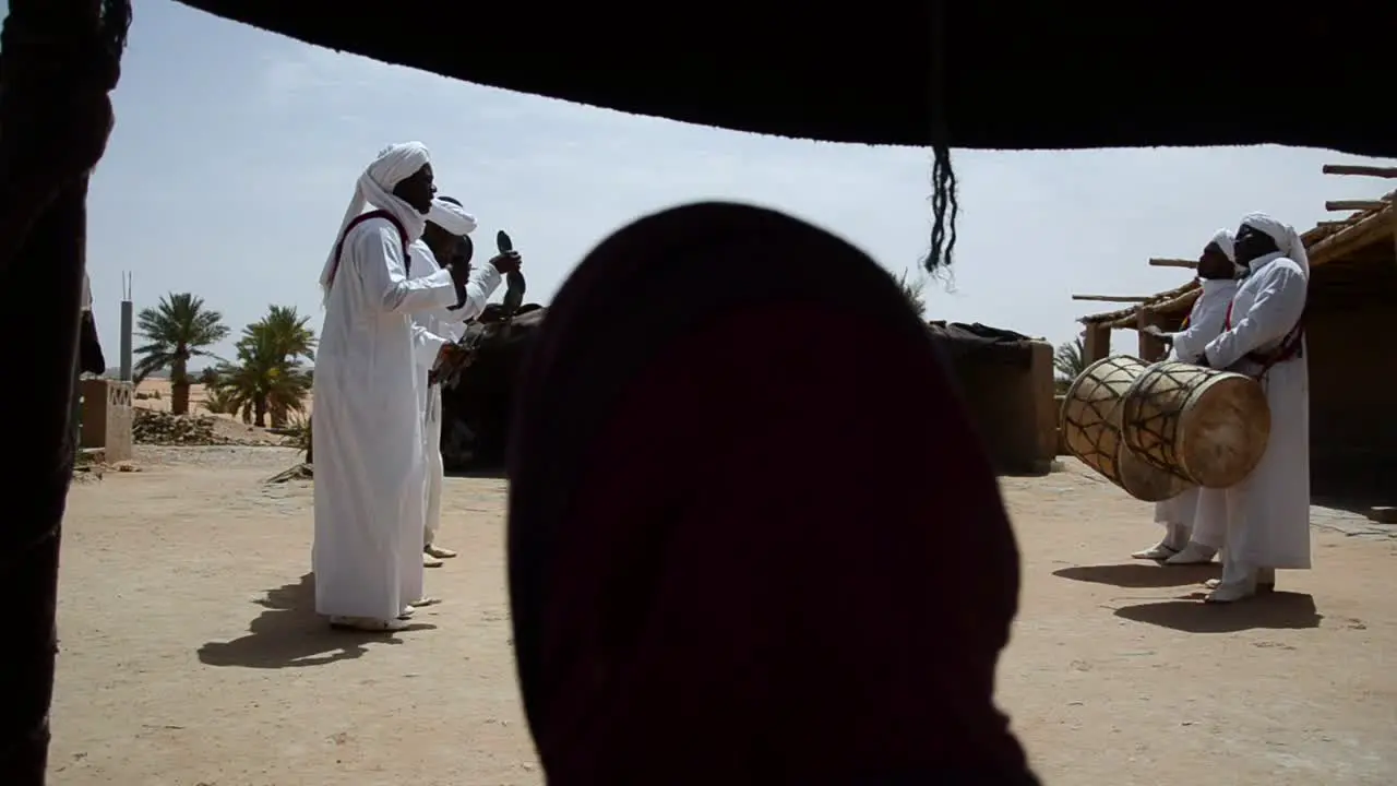 Group of Berberes playing tradicional music and dancing in the Sahara Desert Morocco