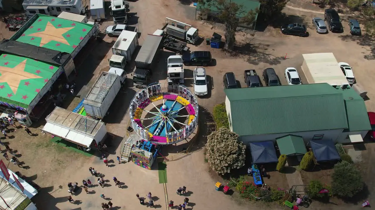 Yarrawonga Victoria Australia 7 October 2023 Aerial rising up view of people on the spinning Tornado amusement ride at the Yarrawonga Show