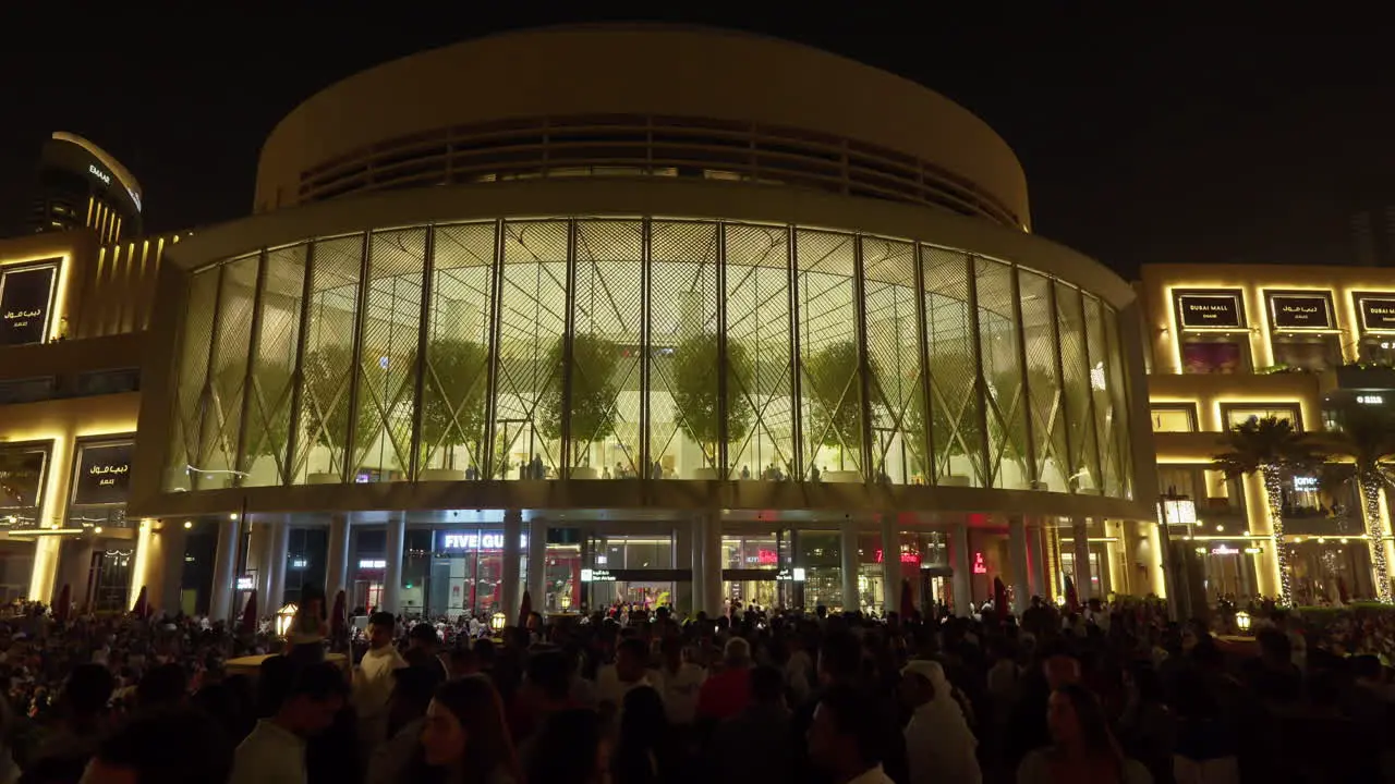 Night view of bustling outdoor mall with lively crowd