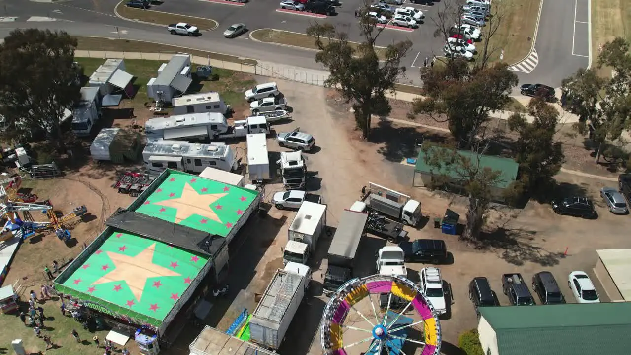 Yarrawonga Victoria Australia 7 October 2023 Aerial tilting down to view people and the spinning Tornado amusement ride at the Yarrawonga Show