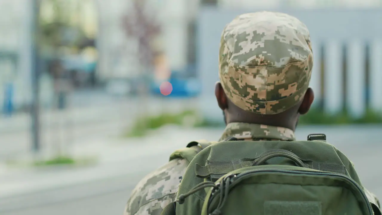 An Soldier In Uniform Walks Outdoors