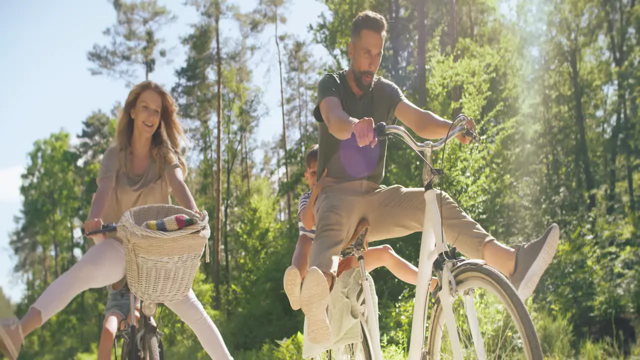 Bottom view of playful family riding bikes in the wood