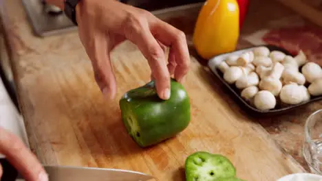 Chef knife hand and cooking pepper