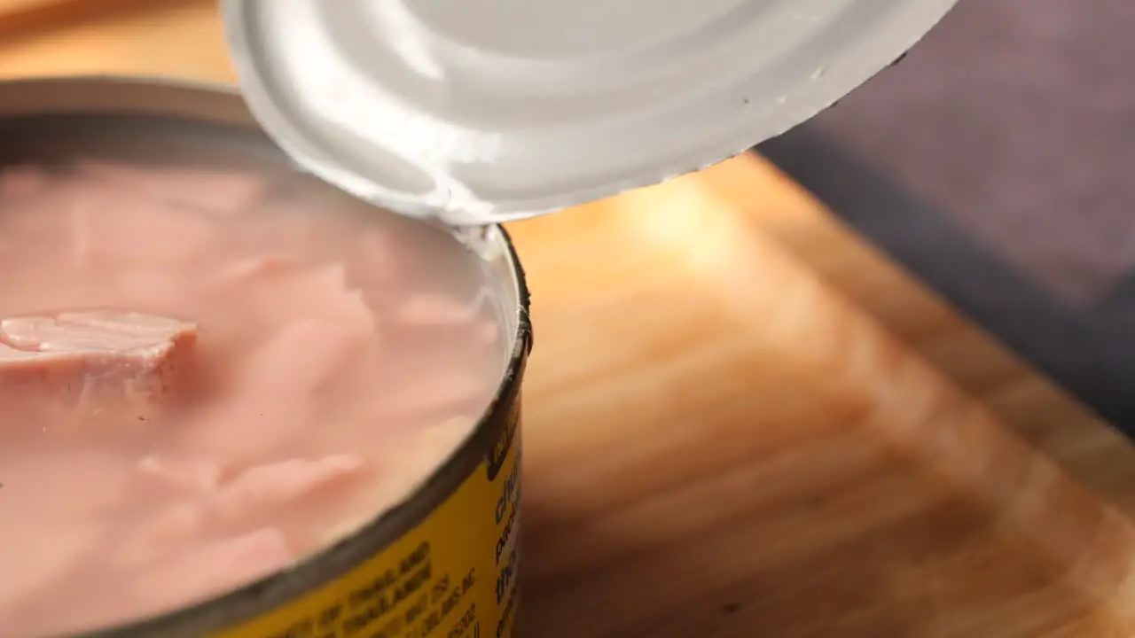 Canned tuna on wooden table