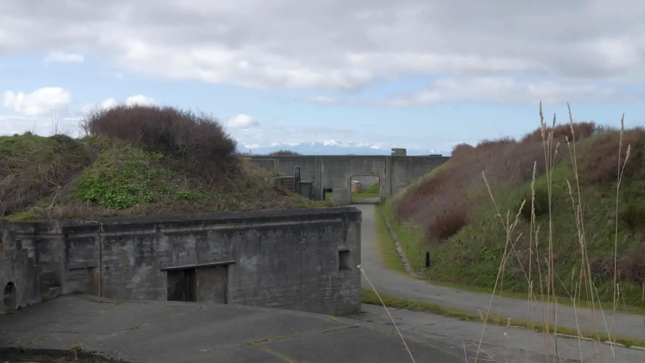 Wide establishing sliding shot of Fort Casey's abandoned military bunkers on Whidbey Island