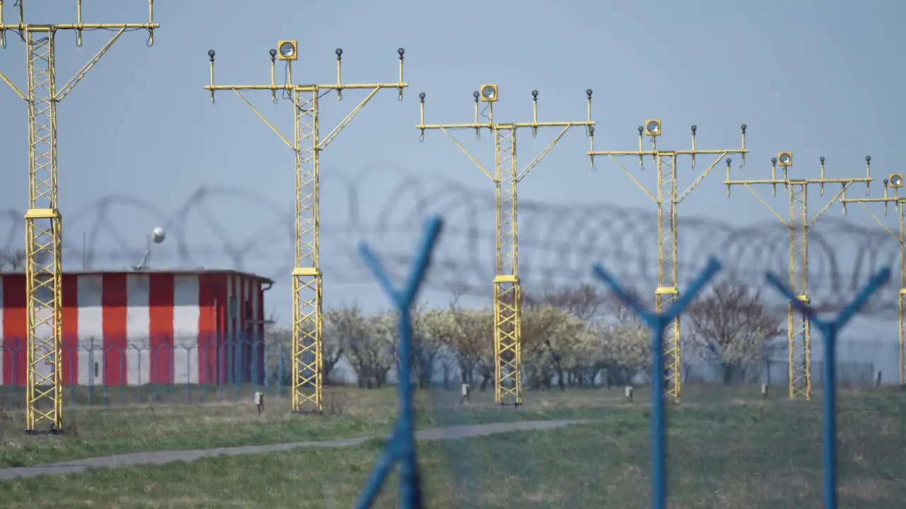 Landing lights of the airport behind the wire fence