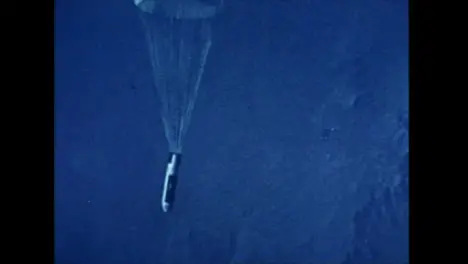 Archive Clip of Hydrogen Bomb Falling From Plane and Deploying Parachute