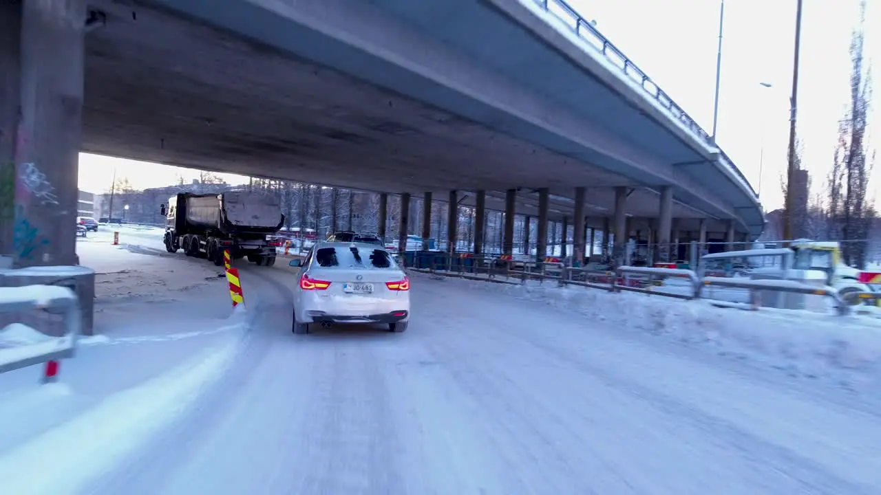 POV driving shot going under highway bridges and passing road works