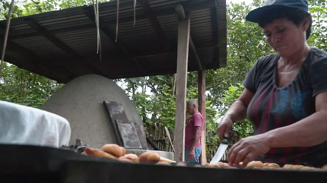 Close Shot Of Woman Using Knife Moving Fresh Bread