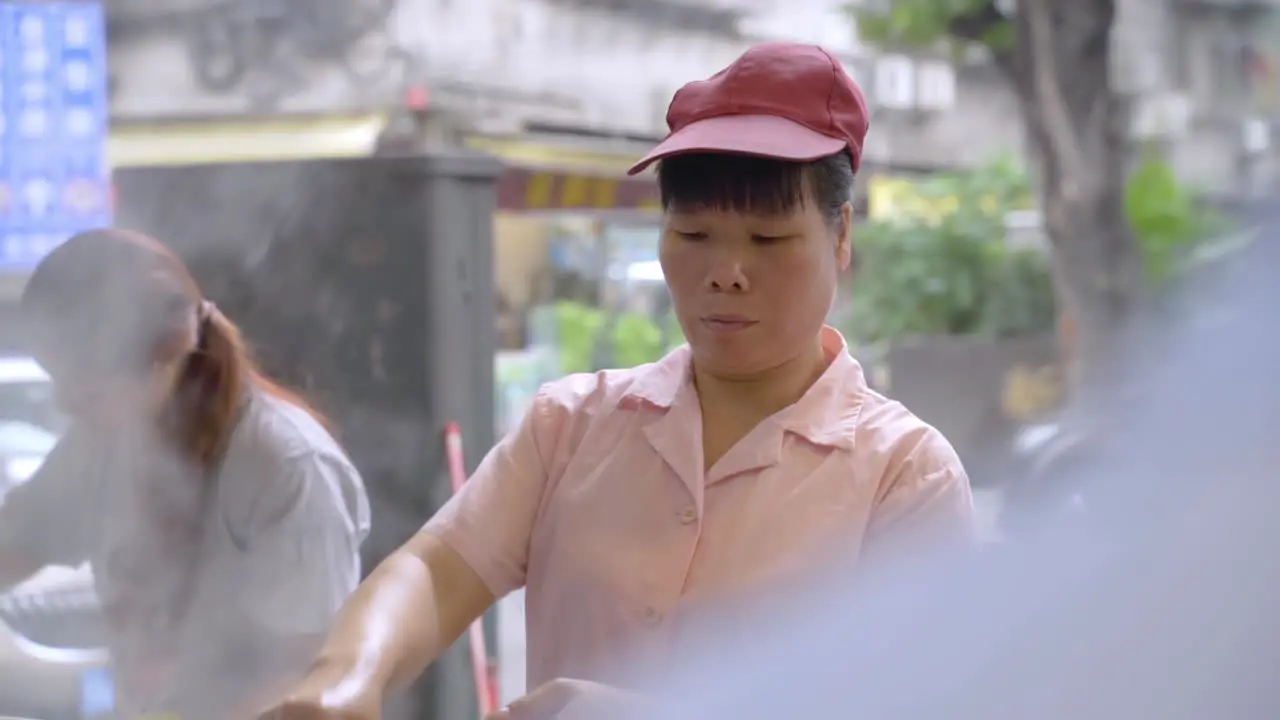 Chinese Female Cook in Authentic Open Restaurant in Guangzhou China Close Up