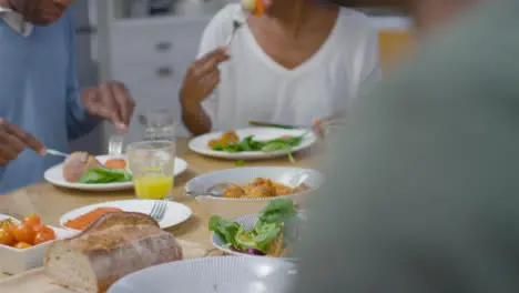 Family Around Table Eating Evening Dinner Together