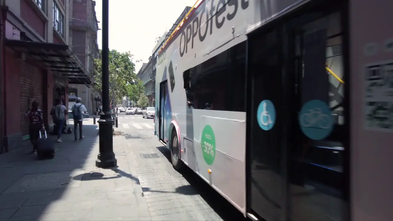 Red Tourist bus named Metrobus driving by one of the streets in Mexico's City downtown