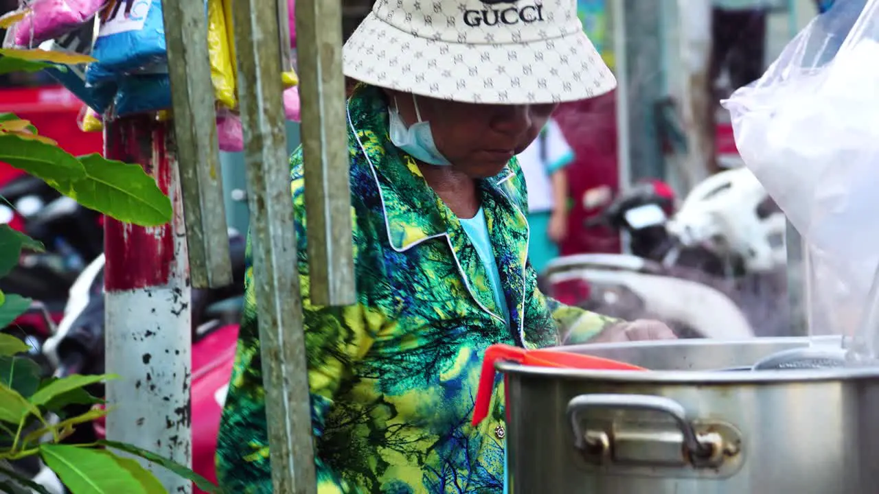 Southeast Asian Vietnamese street food vendor preparing pho soup noodles outdoors