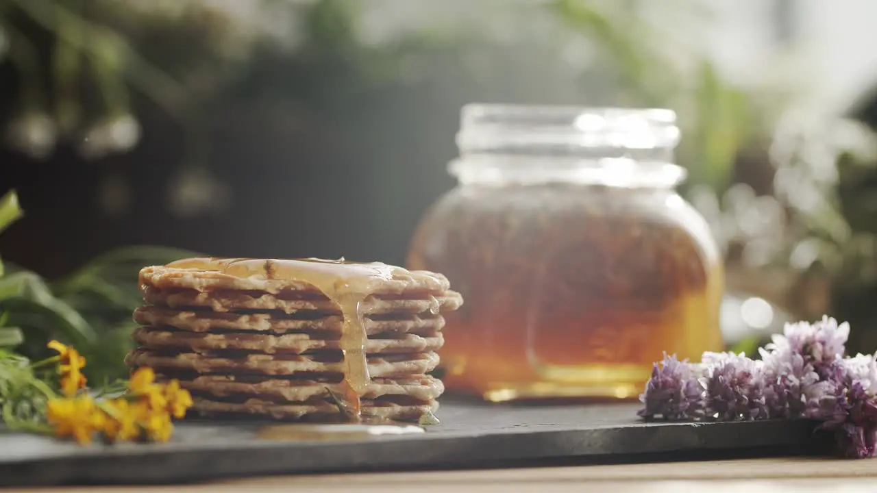 Close-up of honey falling on pancakes