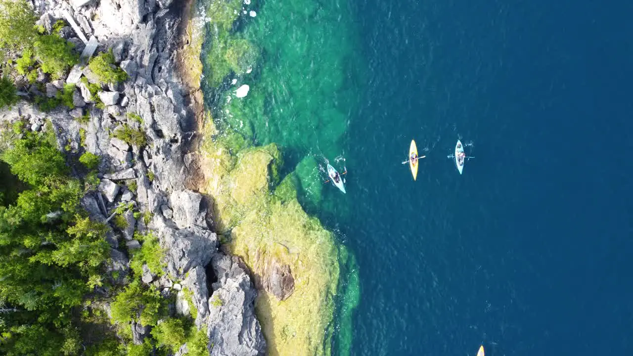 Family kayaking on beautiful Lake Huron aerial topdown