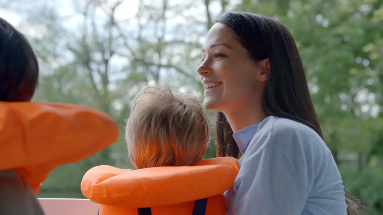 Mother And Sons Enjoy Ride In River Boat Shot In Slow Motion