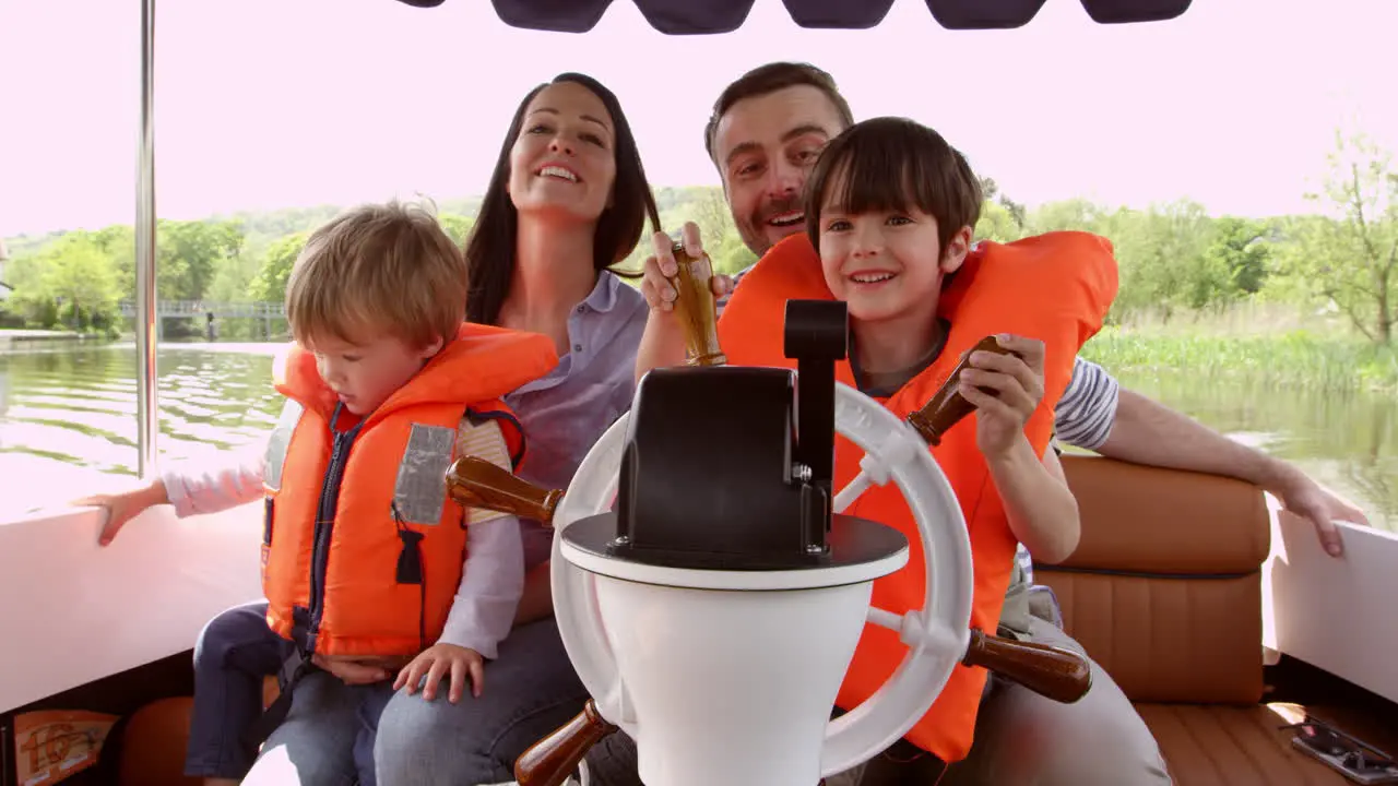 Family Enjoying Day Out In Boat On River Shot On R3D