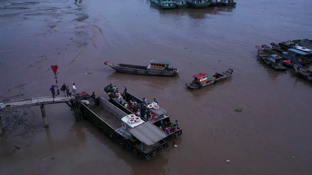 Aerial view of maritime workers boarding small boats at Saigon River jetty Vietnam