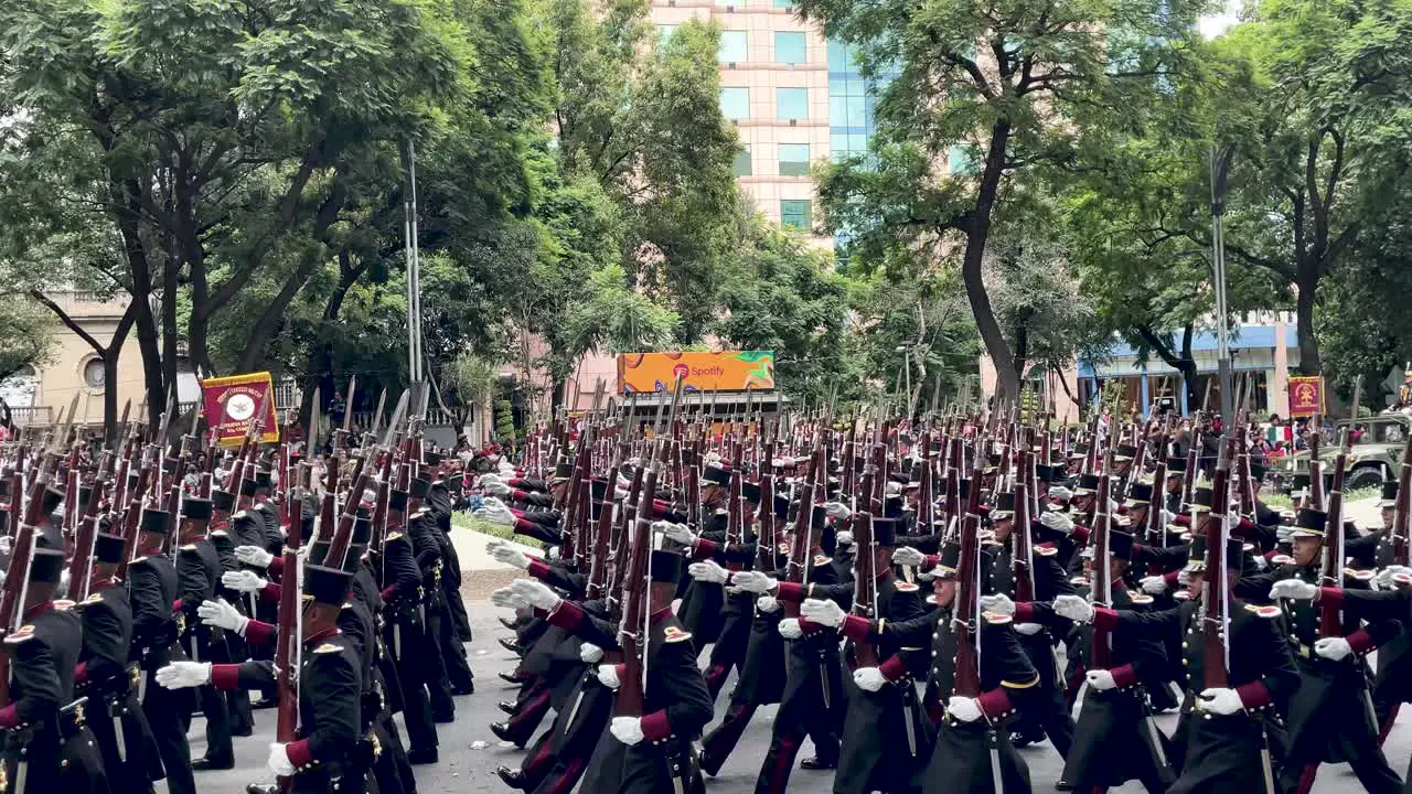 slow motion shot of the body of swordsmen of the mexican army during the military parade in the avenue of the paseo de la reforma in mexico city