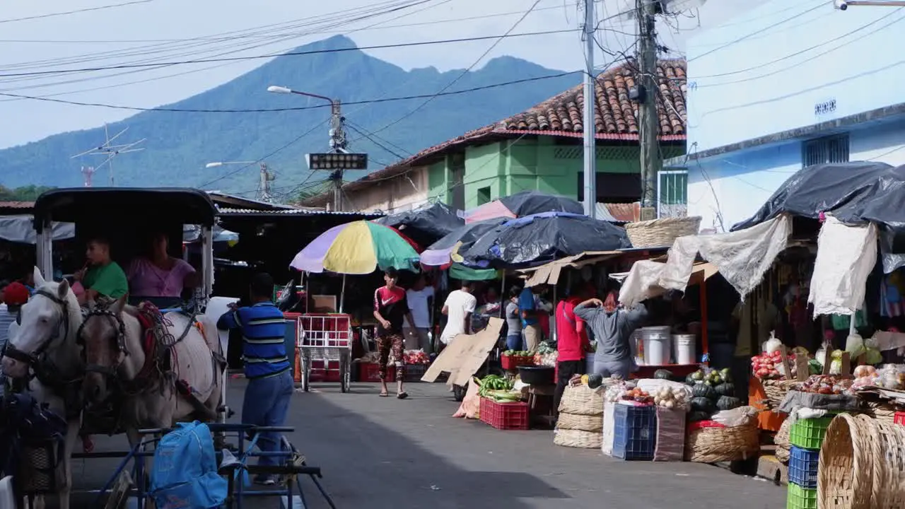 Buyers and sellers meet at narrow street market in Leon Nicaragua