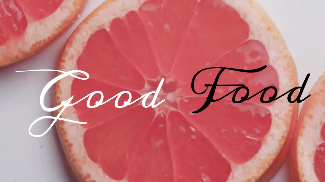 Animation of good food text over fruit falling in water background