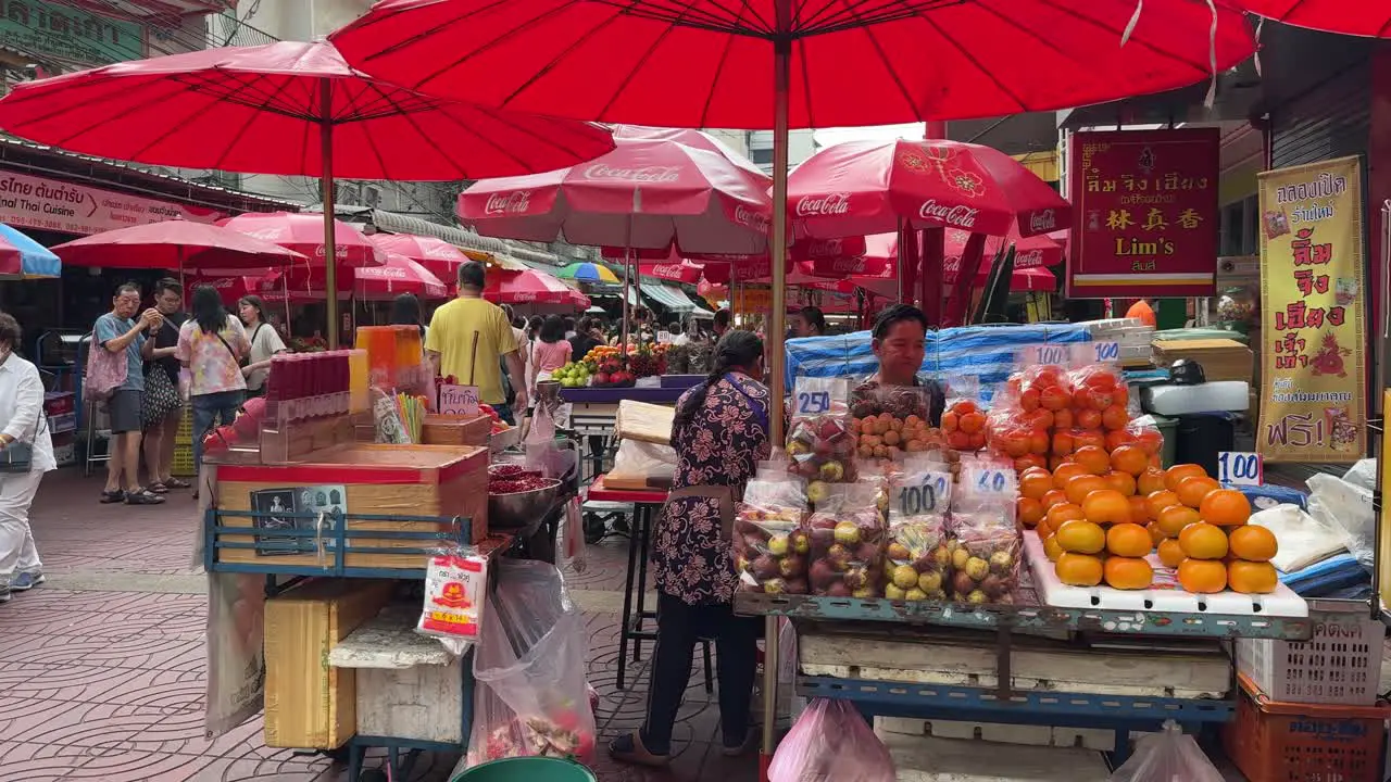 Panning view shot of Street food vendors await customers during one of Thailand's most unique events the Vegetarian Festival – also known as the Nine Emperor Gods Festival in Bangkok