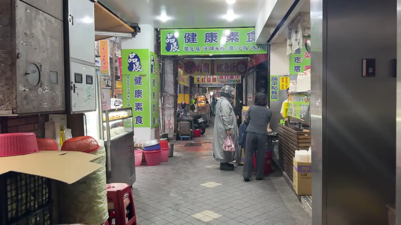 Dolly-in scene of people buying food in a Healthy Vegetarian restaurant in Keelung City Ren’ai District Taiwan