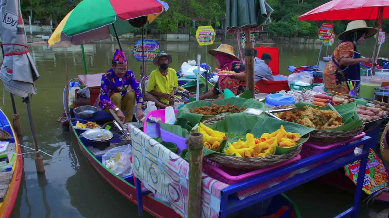 Picturesque scenery of Thai people selling street food from a little wooden rustic boat