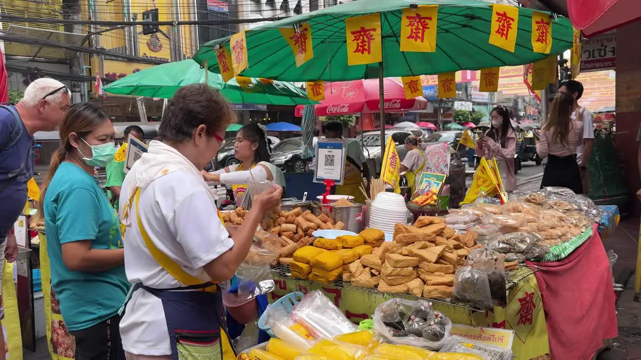 Street food vendors are busy selling and packing food for customers during one of Thailand's most unique events the Vegetarian Festival – also known as the Nine Emperor Gods Festival in Bangkok